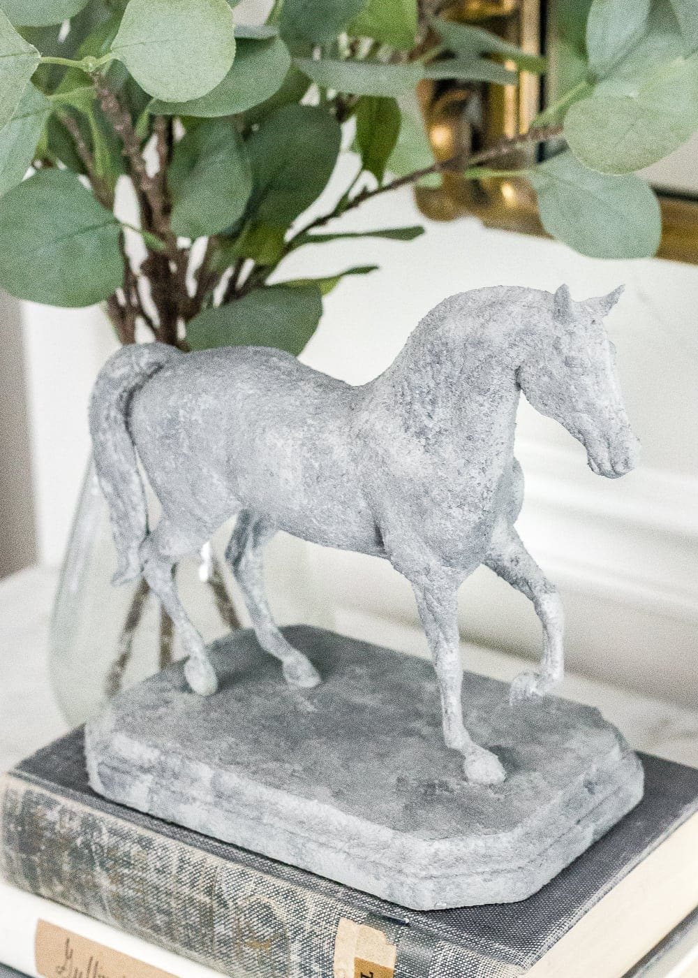How to turn a toy horse figurine into a designer-inspired concrete equestrian statuette using just paint, wood craft, and glue. #thriftymakeover