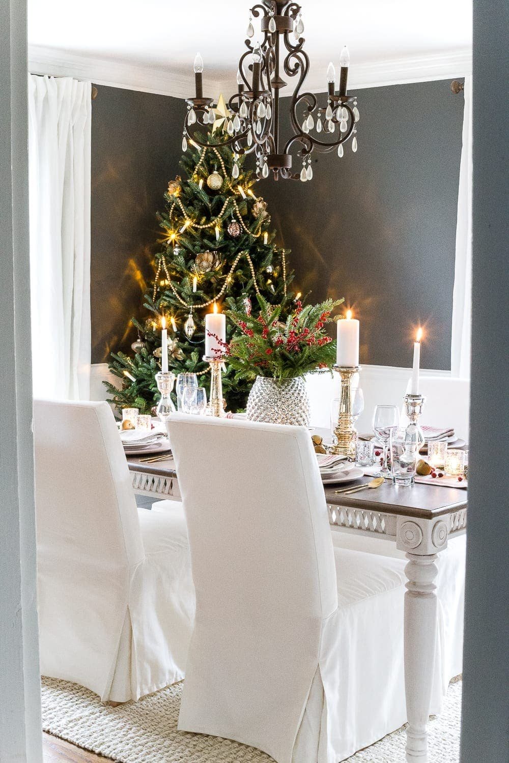 real Christmas tree in a dining room decorated with mercury glass