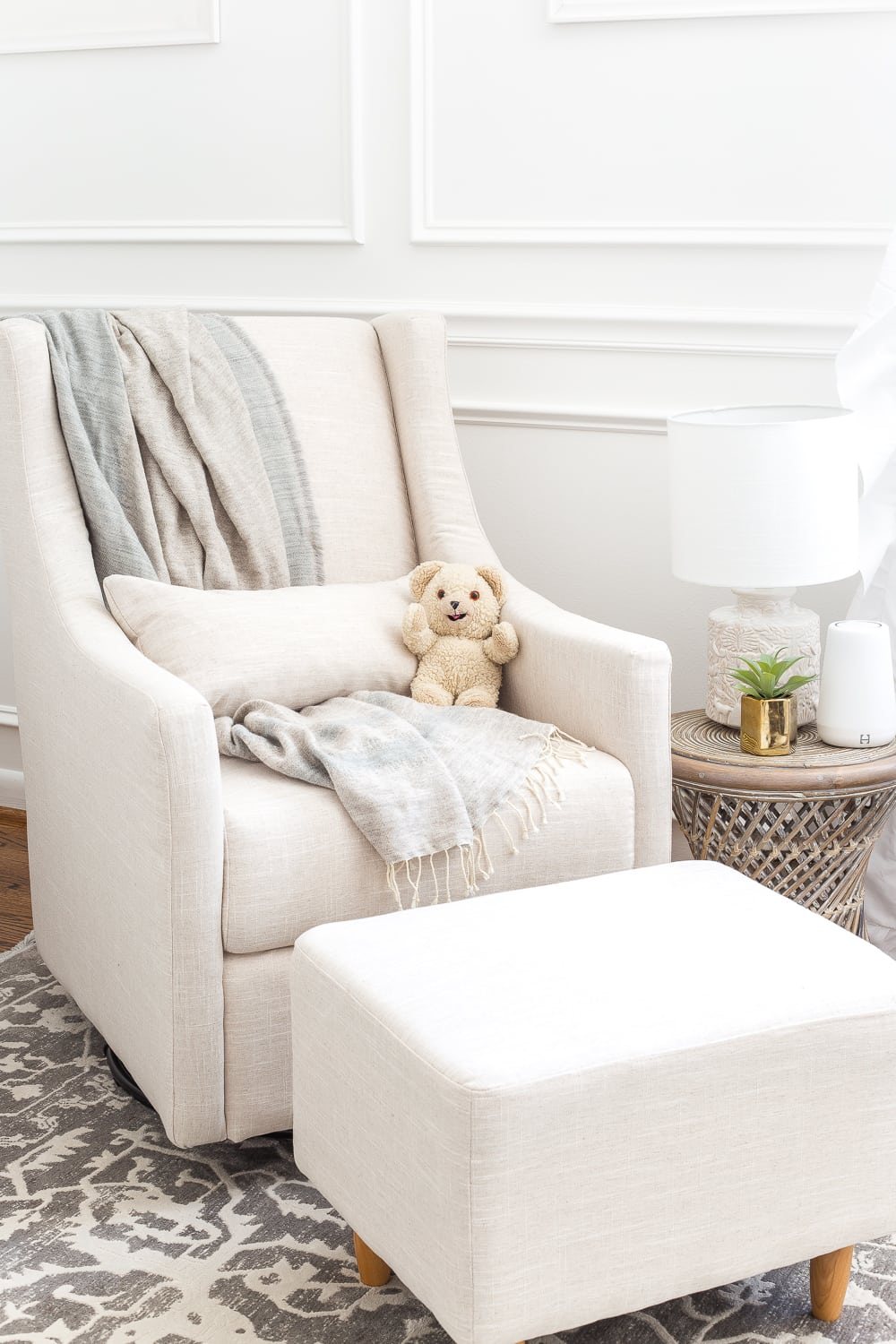An all white nursery makeover room reveal with classic, vintage style furniture, Anthropologie-inspired patterns and textures, and floral accents.