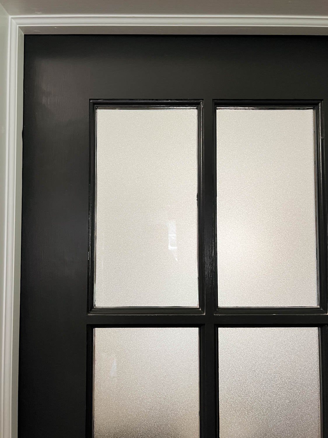 frosted glass film applied onto black French doors