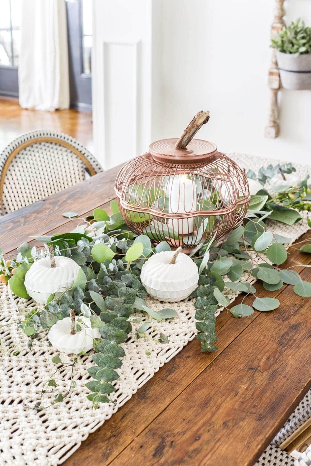 Fall centerpiece with DIY pumpkin lantern using thrifted wire bread baskets and craft pumpkins using mini bundt pan Jello molds