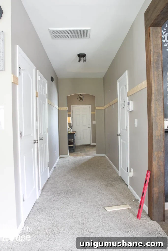 Affordable DIY Board and Batten: Step-by-Step Wall Tutorial 12 adding horizontal board to start board and batten