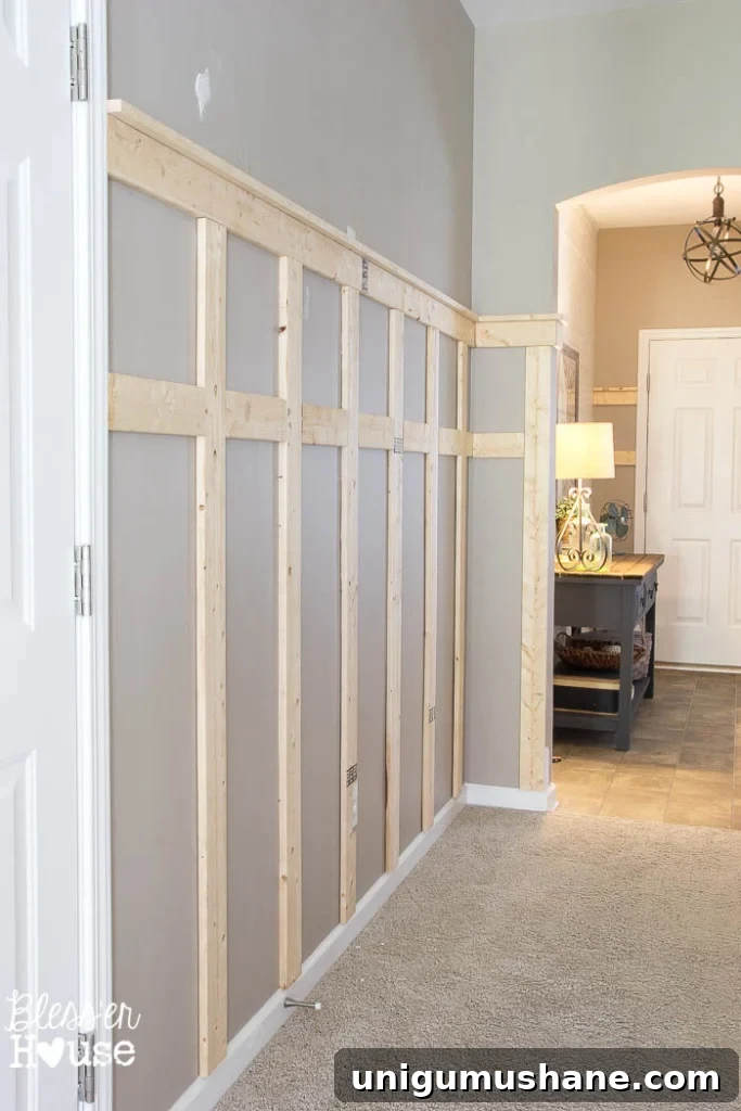Affordable DIY Board and Batten: Step-by-Step Wall Tutorial 22 installing board and batten wainscoting before painting