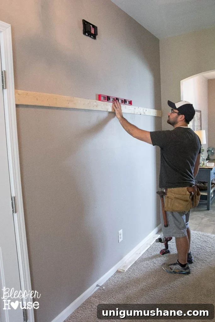 Affordable DIY Board and Batten: Step-by-Step Wall Tutorial 10 checking board to be sure its level