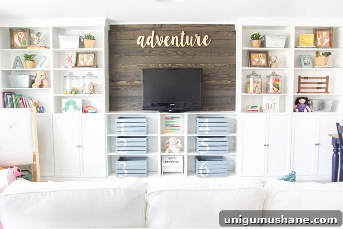 completed DIY built in bookshelves with wood blank wall in a playroom
