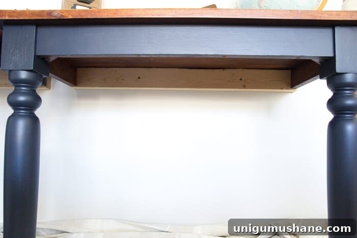 Transform a Kitchen Table into Wall-Mounted Desks: ORC Week 3 4 Repurposed Kitchen Table Turned Desks | blesserhouse.com - How to use a repurposed kitchen table to cut in half and make wall-mounted desks for a playroom makeover with Fusion Mineral Paint Midnight Blue.