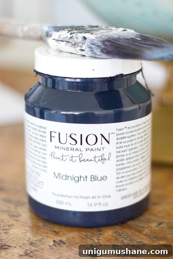 Transform a Kitchen Table into Wall-Mounted Desks: ORC Week 3 5 Repurposed Kitchen Table Turned Desks | blesserhouse.com - How to use a repurposed kitchen table to cut in half and make wall-mounted desks for a playroom makeover with Fusion Mineral Paint Midnight Blue.