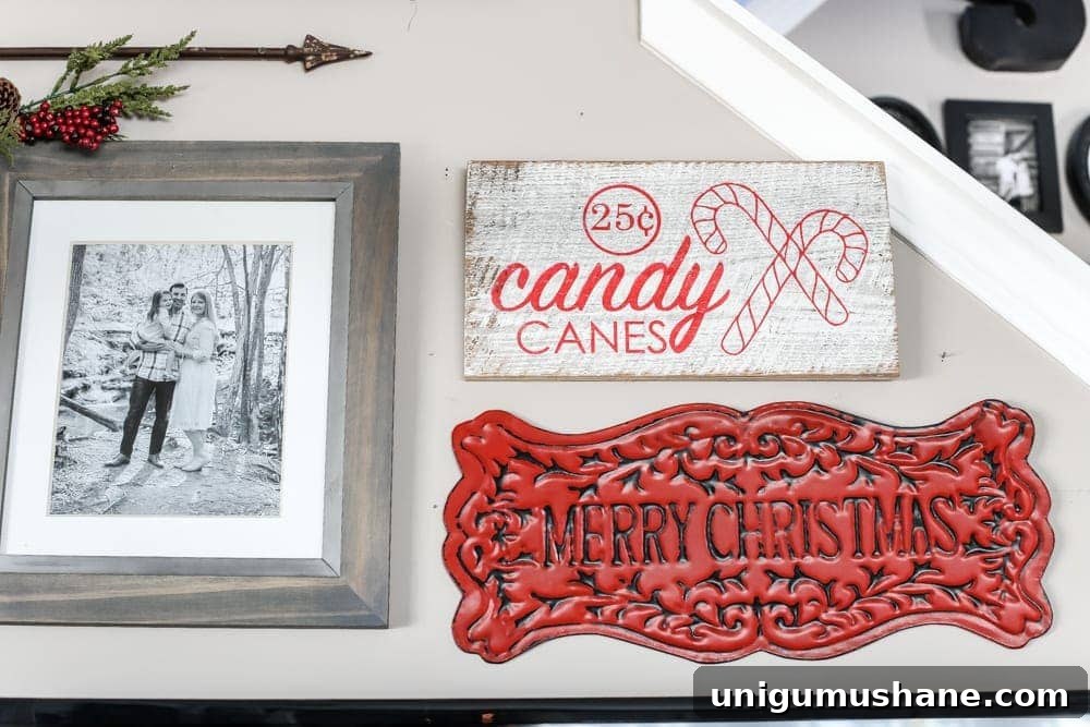 Cozy Christmas Living Room Tour with Holiday Decor Ideas 8 Farmhouse Christmas gallery wall with garland, wreaths, lanterns, and seasonal signs.