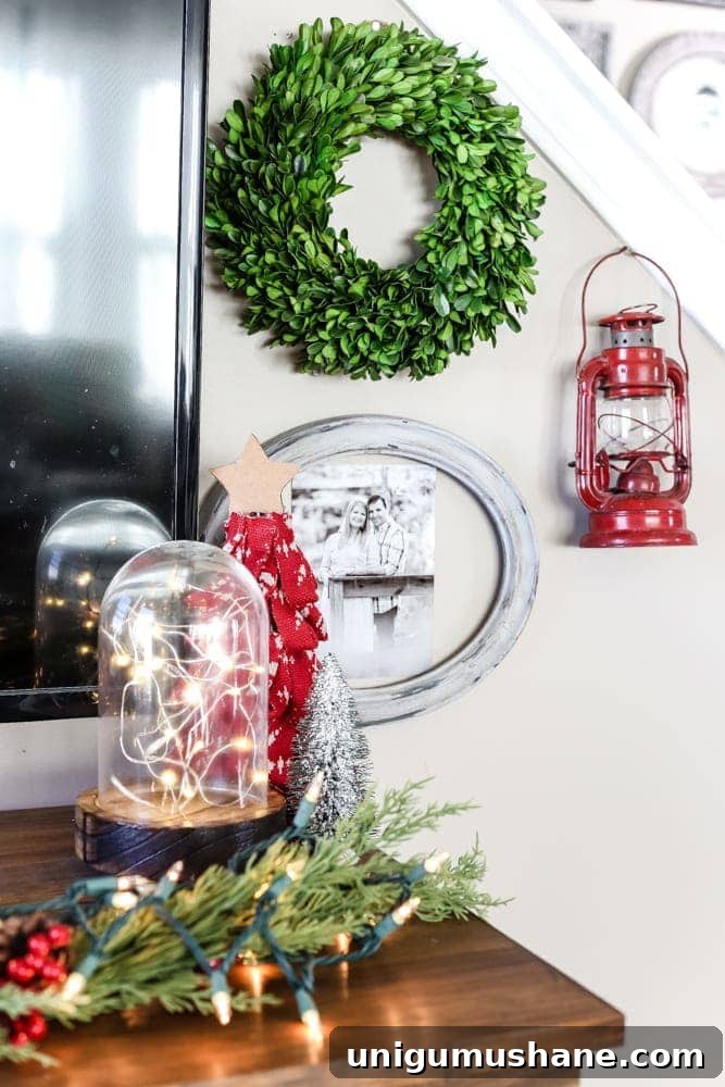Cozy Christmas Living Room Tour with Holiday Decor Ideas 9 Christmas gallery wall with rustic frames, greenery, red accents, and cozy farmhouse charm.