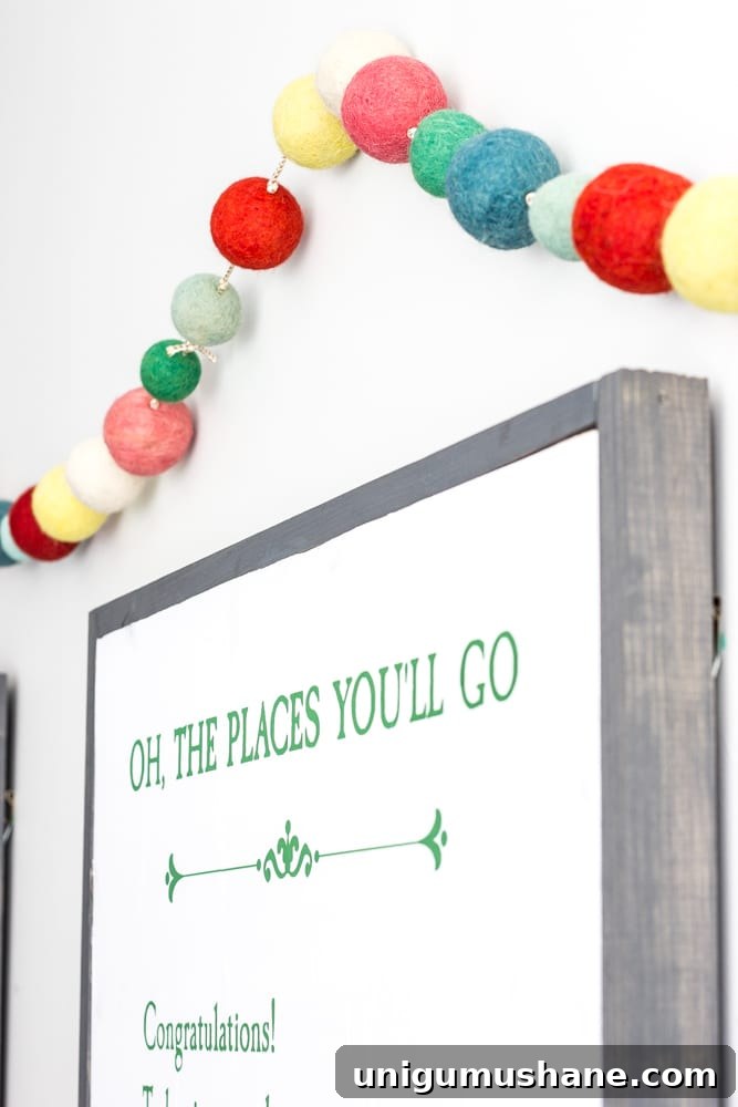 One Room Challenge Week 6: Eclectic Farmhouse Playroom Reveal 15 Pom pom garland and storybook page art