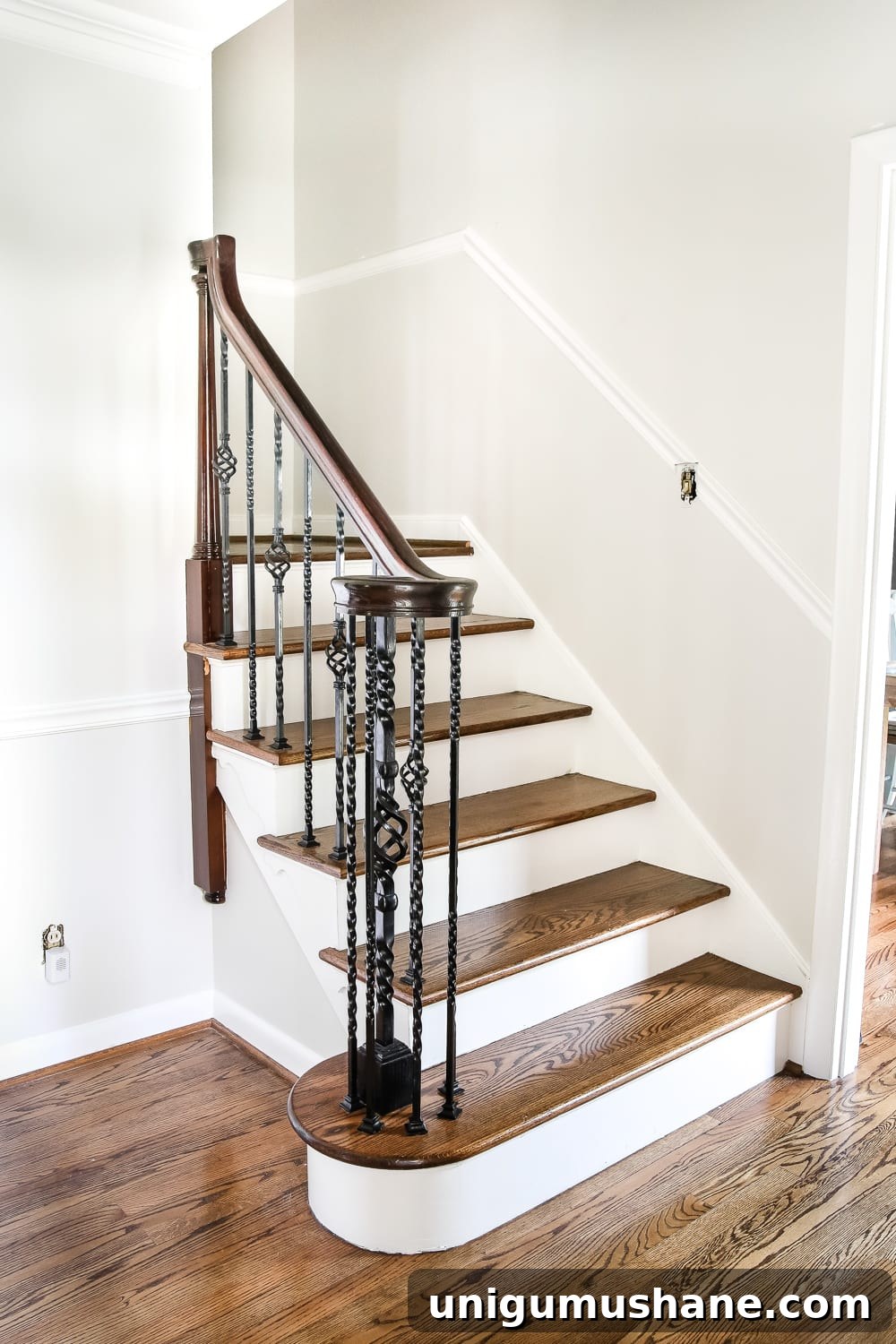 Neutral Paint Ideas to Update Your Foyer 6 Neutral Painted Foyer Update | Blesserhouse.com - A drab, dated foyer and staircase get a bright, neutral facelift with high contrast details using Benjamin Moore colors Classic Gray and Wrought Iron.