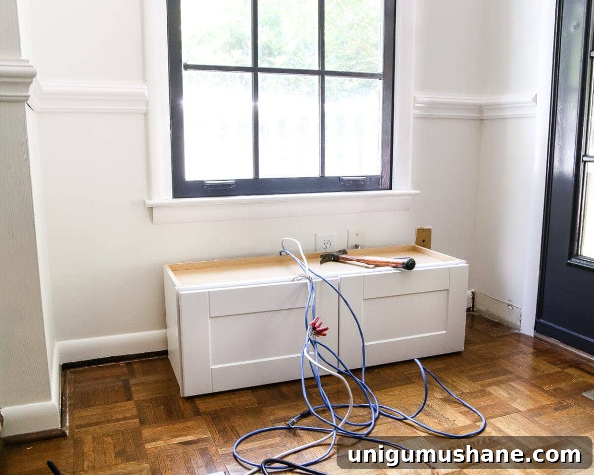 DIY Window Seat from a Kitchen Cabinet | blesserhouse.com - A simplified tutorial for how to build a DIY window seat using a prefabbed kitchen cabinet to house electronics and hide cords.