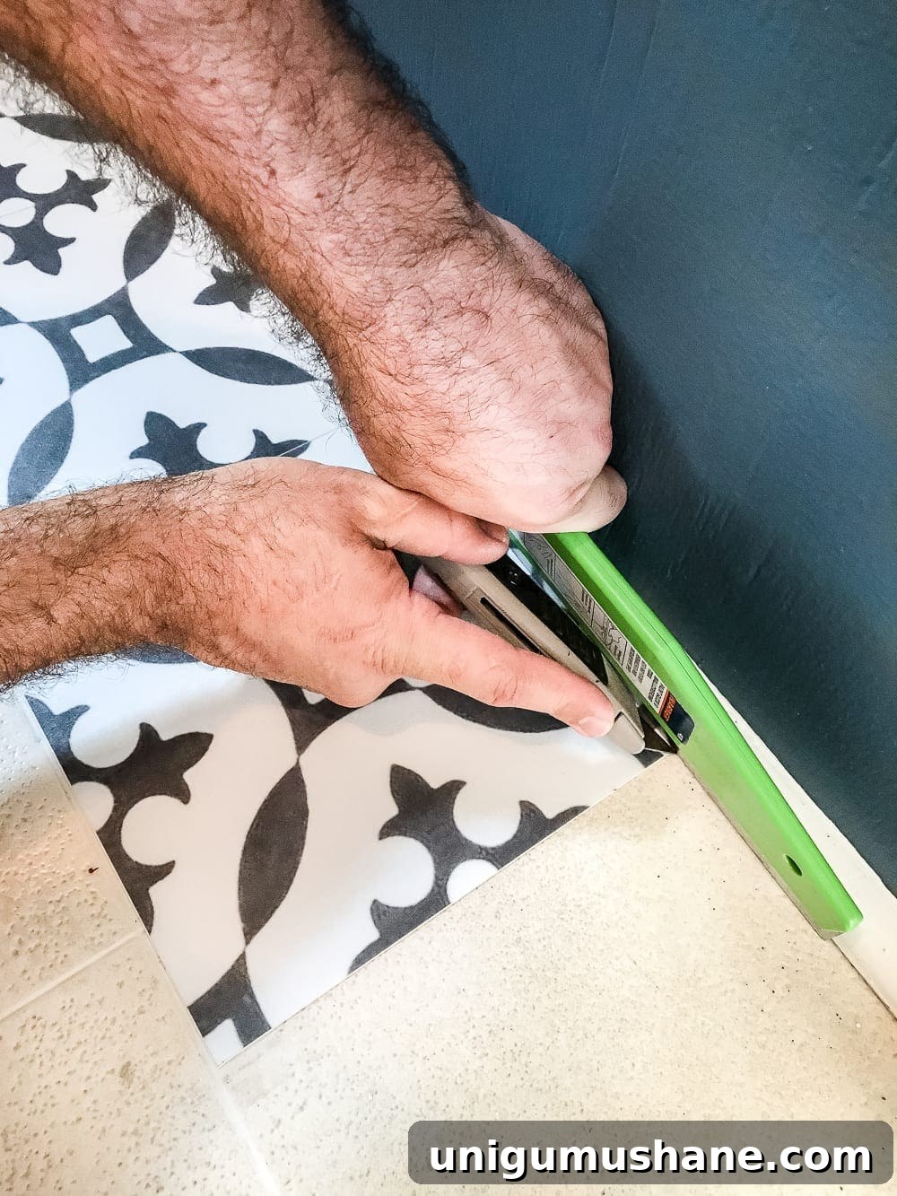 DIY Moroccan Vinyl Tile Flooring Makeover 6 Smoothing peel and stick vinyl tile during installation