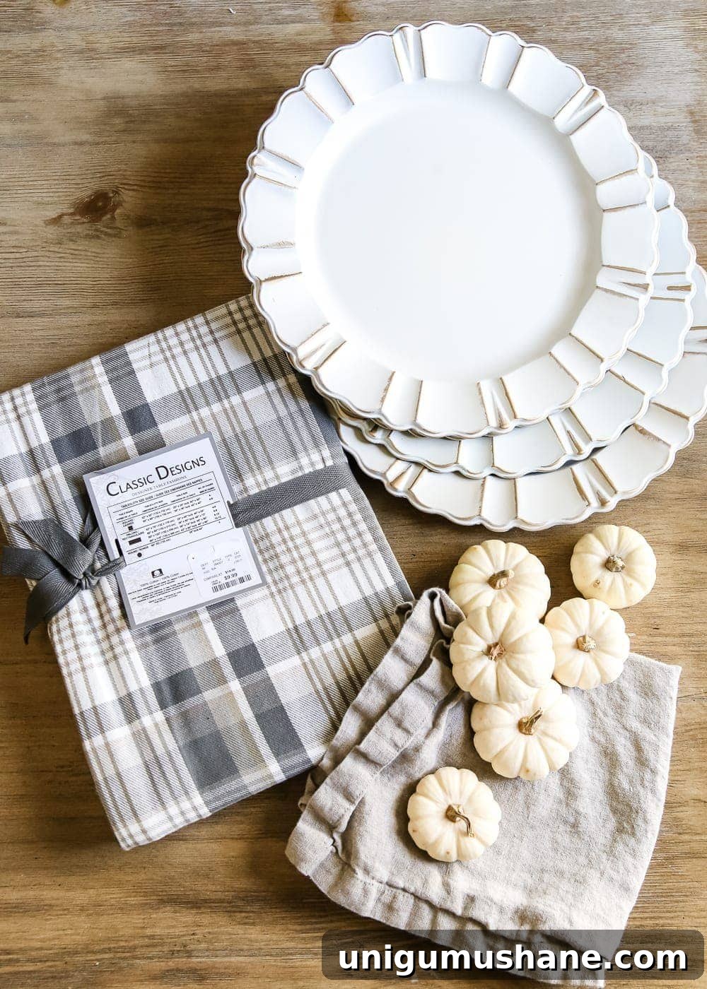 Neutral Thanksgiving Tablescape Ideas for an Understated Fall Table 4 Neutral Low-Key Thanksgiving Tablescape | blesserhouse.com - A neutral low-key Thanksgiving tablescape that is simple and inexpensive to recreate using plaid fabric, white pumpkins, eucalyptus, and brass.