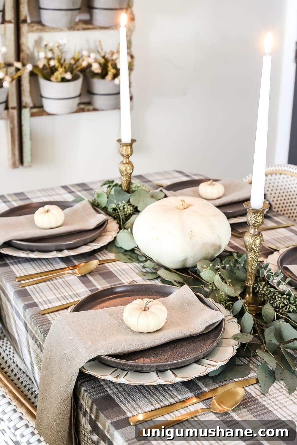 Neutral Thanksgiving Tablescape Ideas for an Understated Fall Table 5 Neutral Low-Key Thanksgiving Tablescape | blesserhouse.com - A neutral low-key Thanksgiving tablescape that is simple and inexpensive to recreate using plaid fabric, white pumpkins, eucalyptus, and brass.