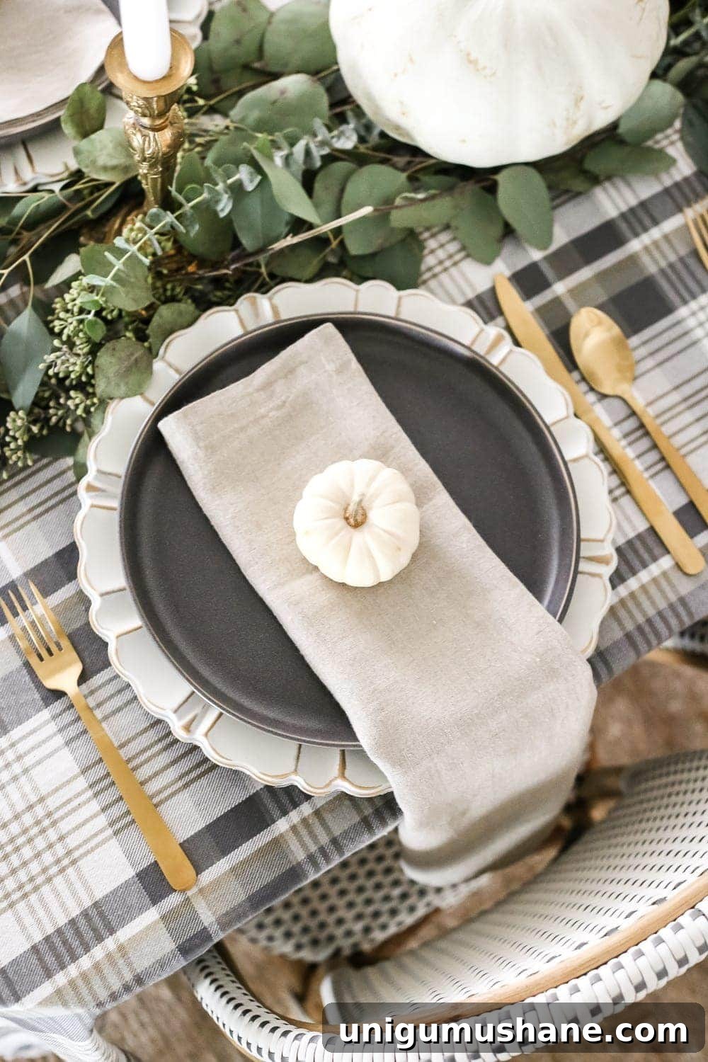 Neutral Thanksgiving Tablescape Ideas for an Understated Fall Table 6 Neutral Low-Key Thanksgiving Tablescape | blesserhouse.com - A neutral low-key Thanksgiving tablescape that is simple and inexpensive to recreate using plaid fabric, white pumpkins, eucalyptus, and brass.