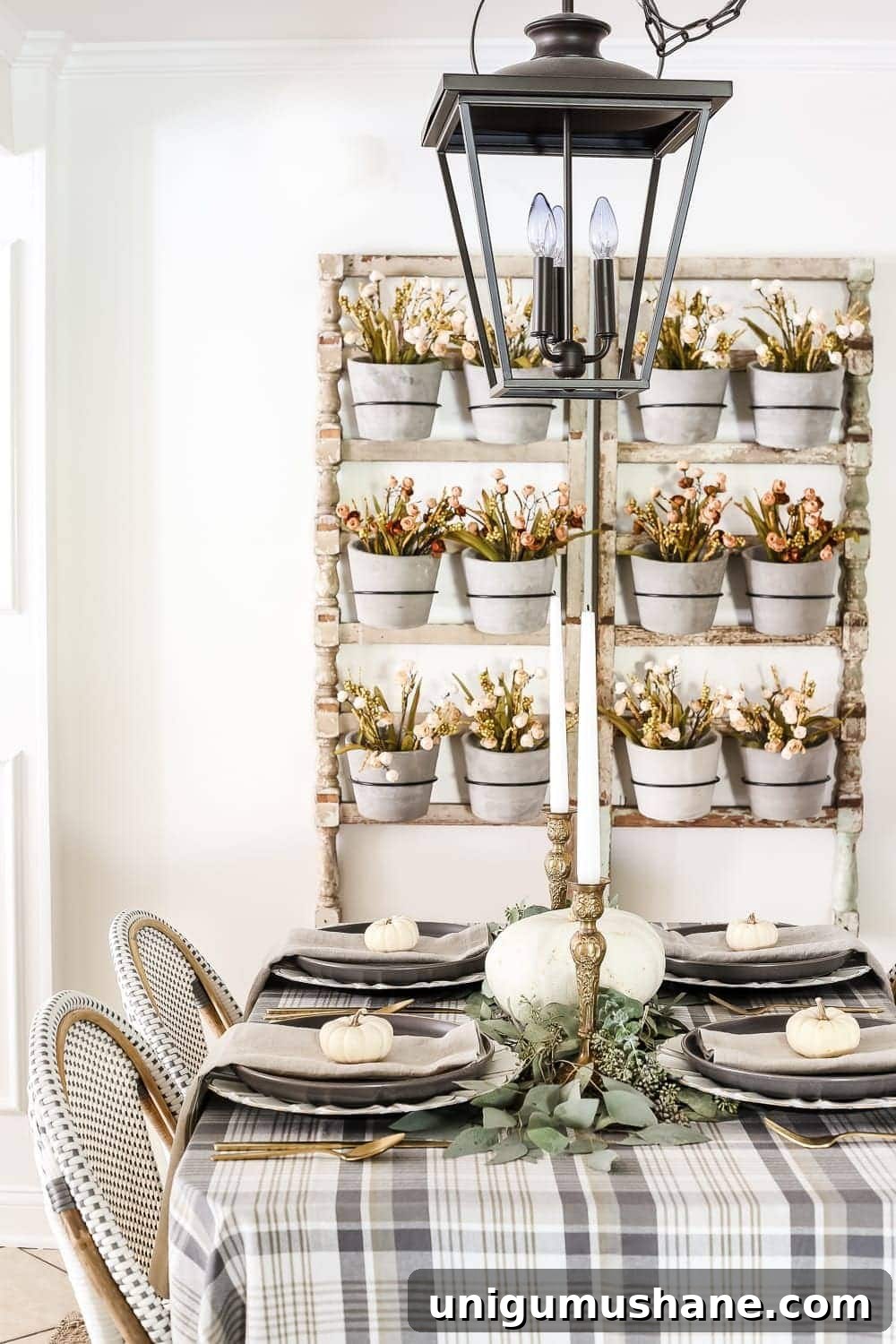 Neutral Thanksgiving Tablescape Ideas for an Understated Fall Table 9 Neutral Low-Key Thanksgiving Tablescape | blesserhouse.com - A neutral low-key Thanksgiving tablescape that is simple and inexpensive to recreate using plaid fabric, white pumpkins, eucalyptus, and brass.