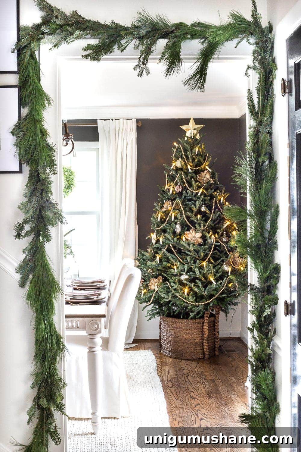 How to Decorate a Real Christmas Tree: Step-by-Step 2 live Christmas tree in dining room and real pine garland surrounding doorway