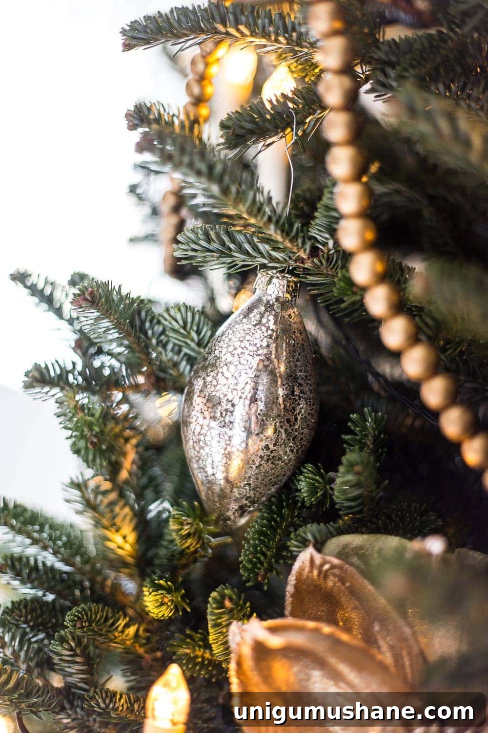 How to Decorate a Real Christmas Tree: Step-by-Step 10 mercury glass ornament on a tree branch