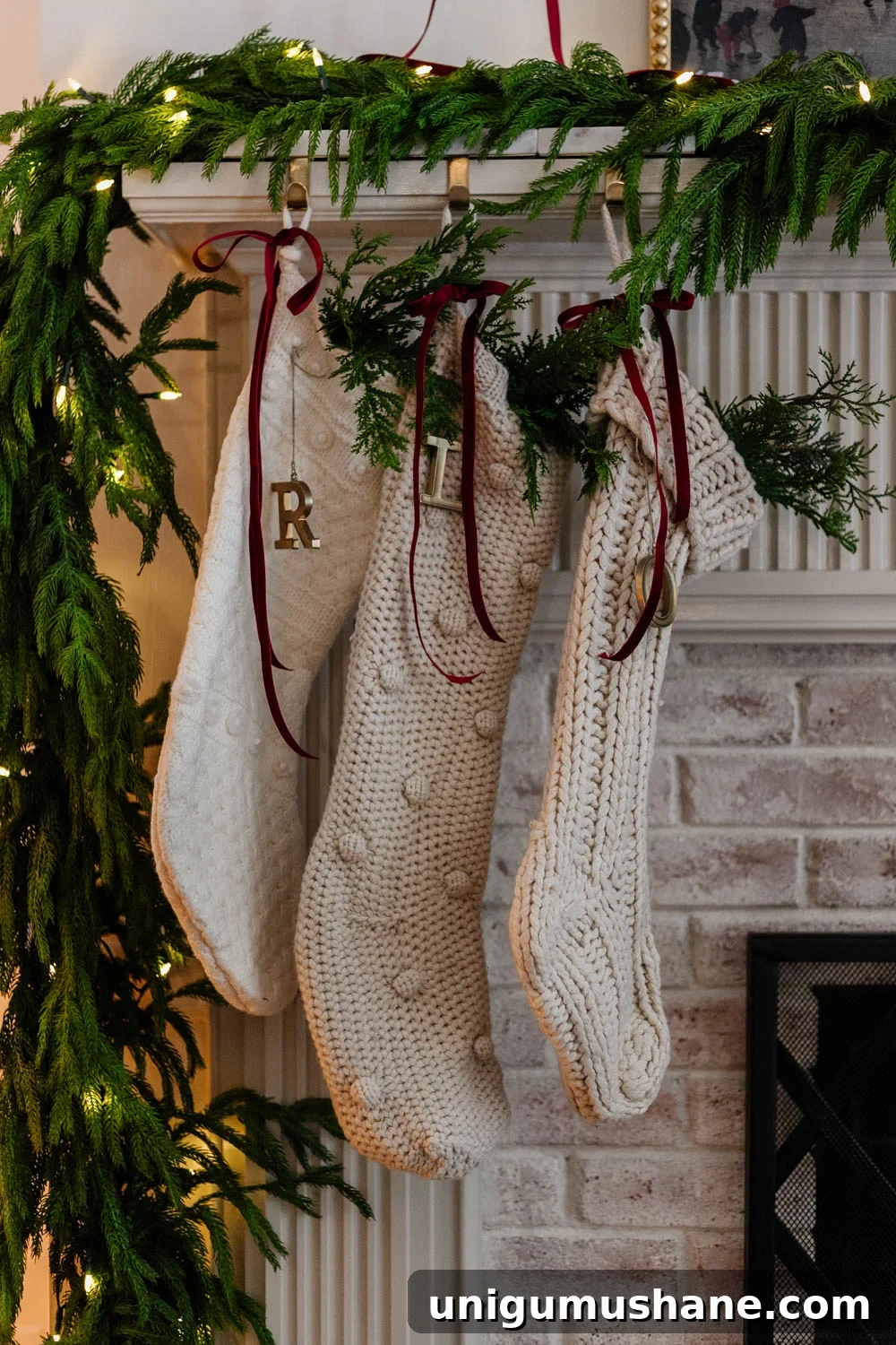 250 Stocking Stuffer Ideas for Families in 2025 8 christmas stockings on a mantel with red ribbon