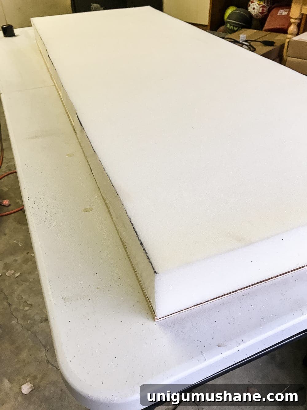 How to Turn a Coffee Table into an Ottoman Bench 10 Spray adhesive bonding foam to plywood