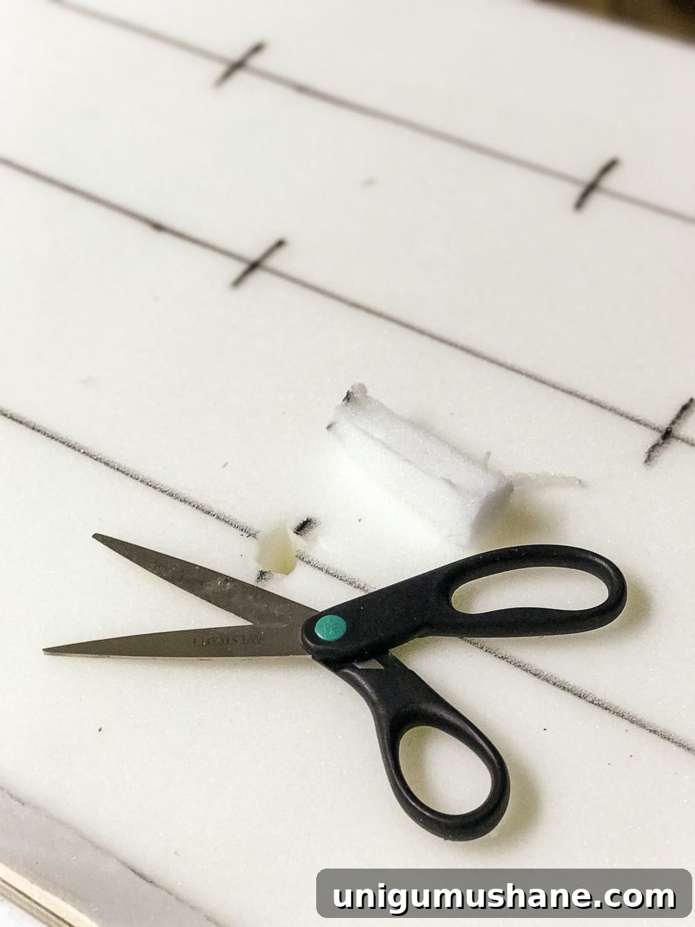How to Turn a Coffee Table into an Ottoman Bench 12 Cutting slits for tufting