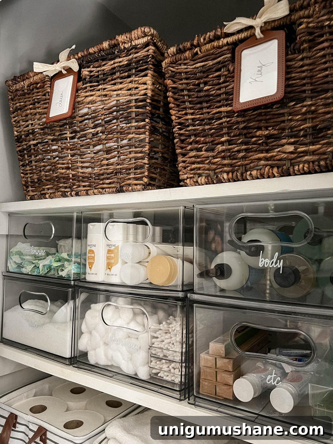 pair of baskets storing sheets on linen closet shelving