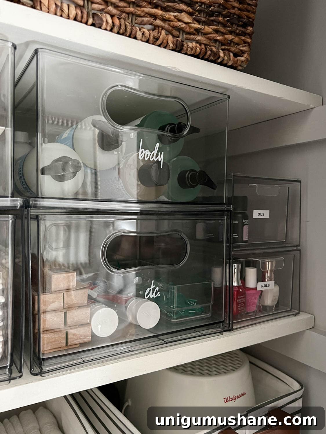 clear storage bins with labels for bathroom supplies
