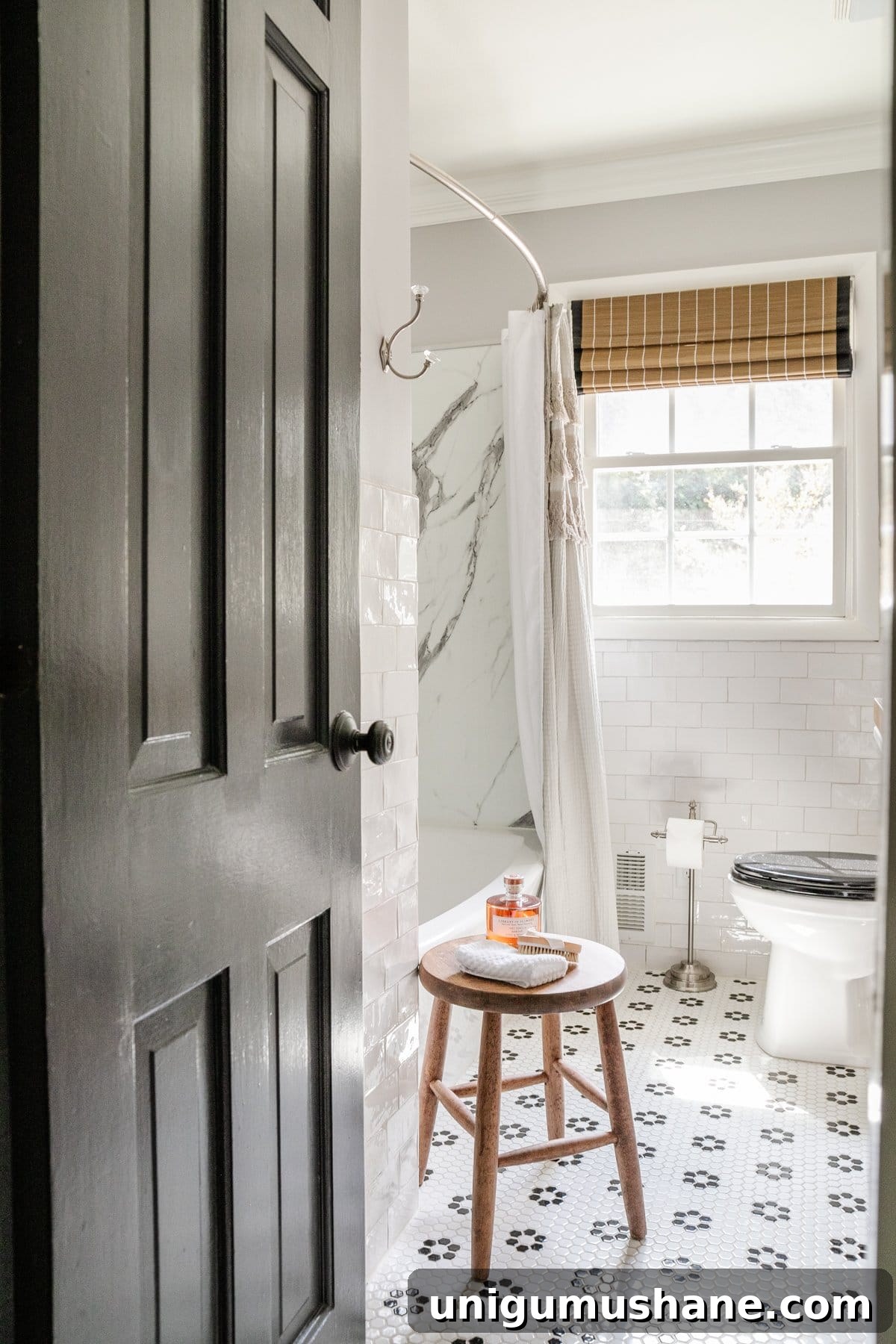 Timeless Interior Design Trends for Your Home 5 black and white bathroom with subway tile, black door, and retro tile floor