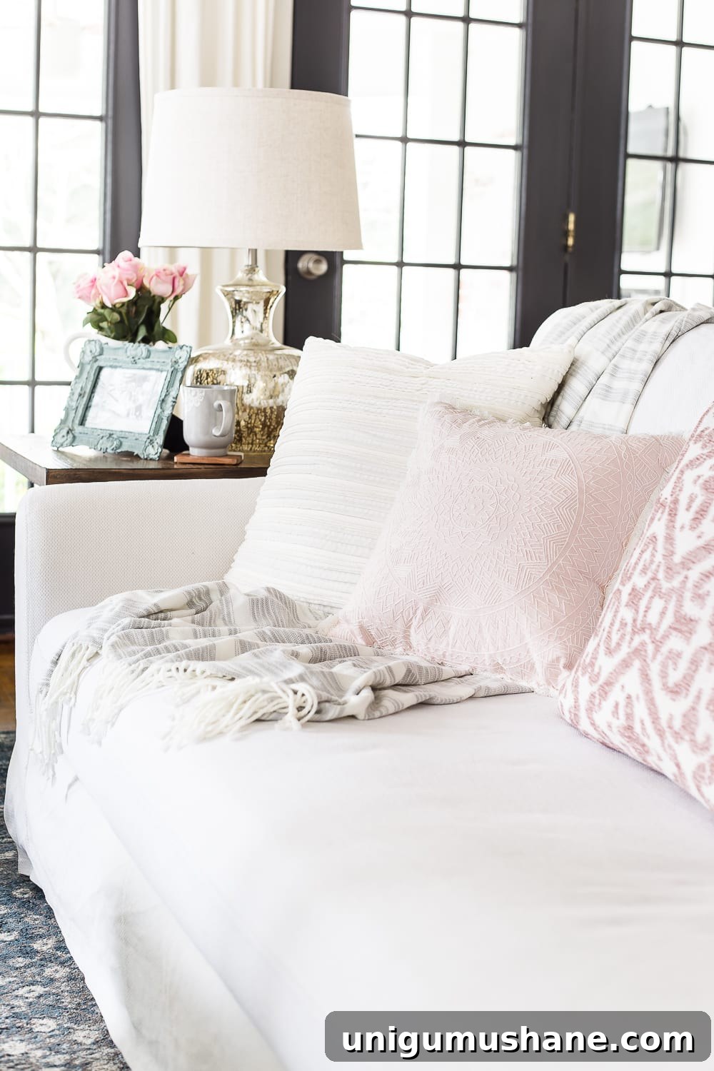 Spring Living Room Tour: Fresh Decor Ideas 8 A living room gets a spring refresh with simple florals, candle light, and light fabrics. #springdecor #livingroom #springlivingroom #springaccents #livingroomdesign #livingroomdecor #budgetdecor