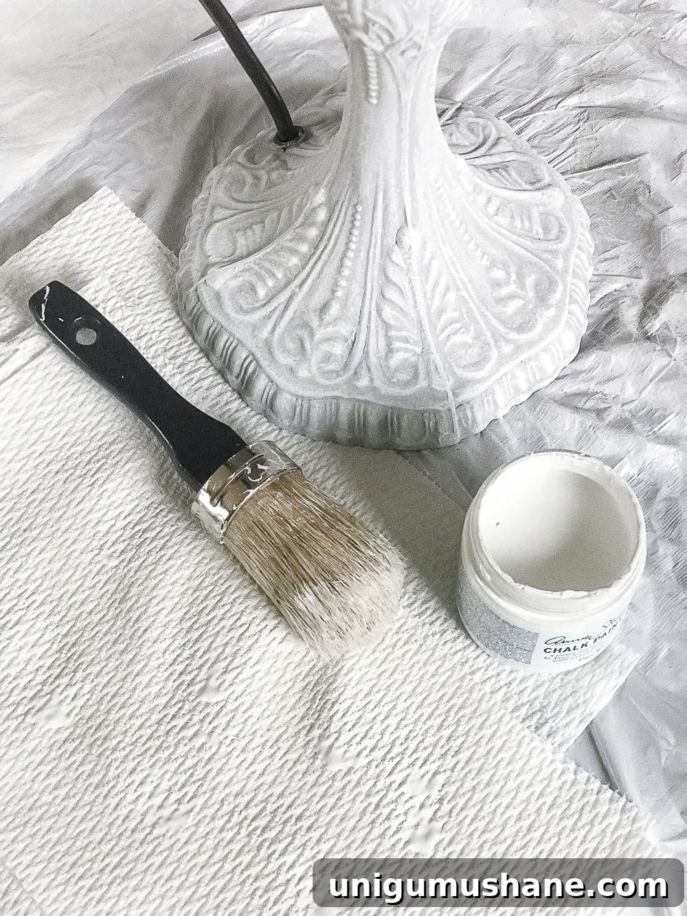 A thrifted table lamp gets a French Baroque designer inspired makeover using Annie Sloan Chalk Paint in Paris Grey, Pure White, clear wax, and dark wax.