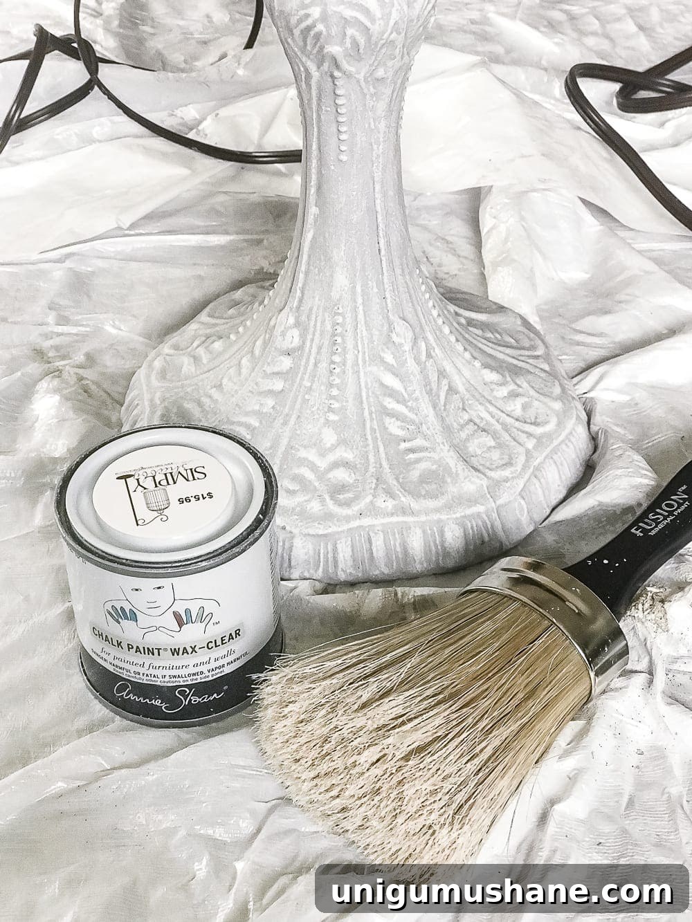 A thrifted table lamp gets a French Baroque designer inspired makeover using Annie Sloan Chalk Paint in Paris Grey, Pure White, clear wax, and dark wax.