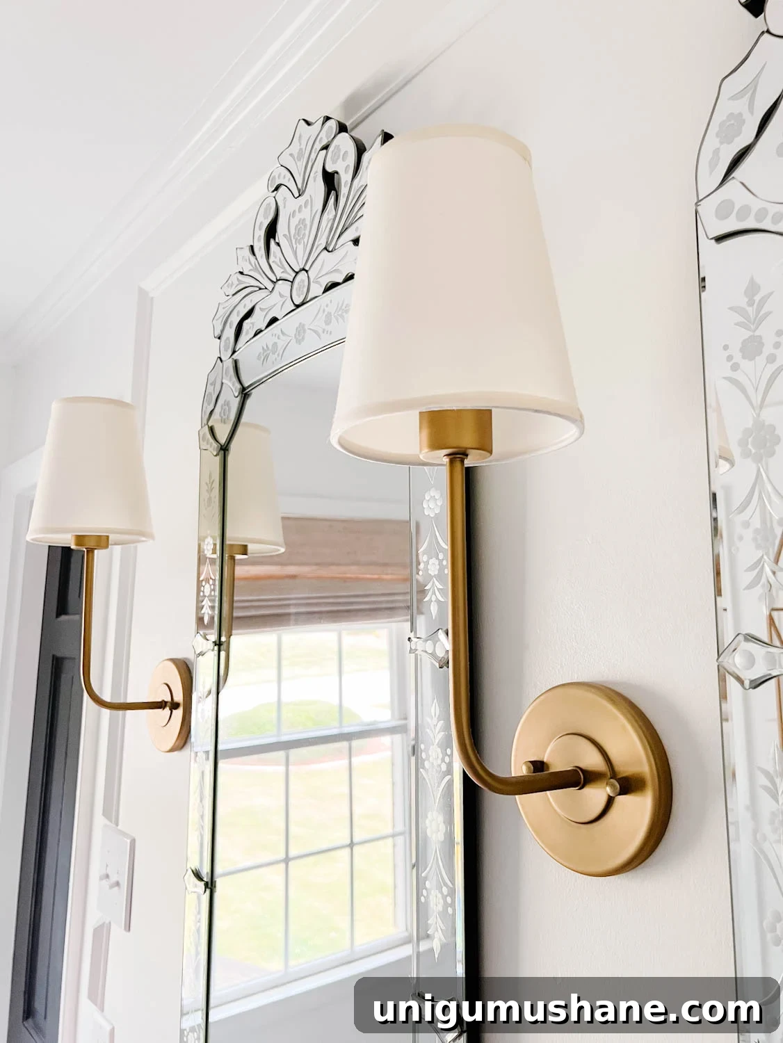 Vintage Wall Sconces: 32 Stylish Picks for Every Room 2 vintage wall sconces on either side of Venetian mirrors in a bathroom