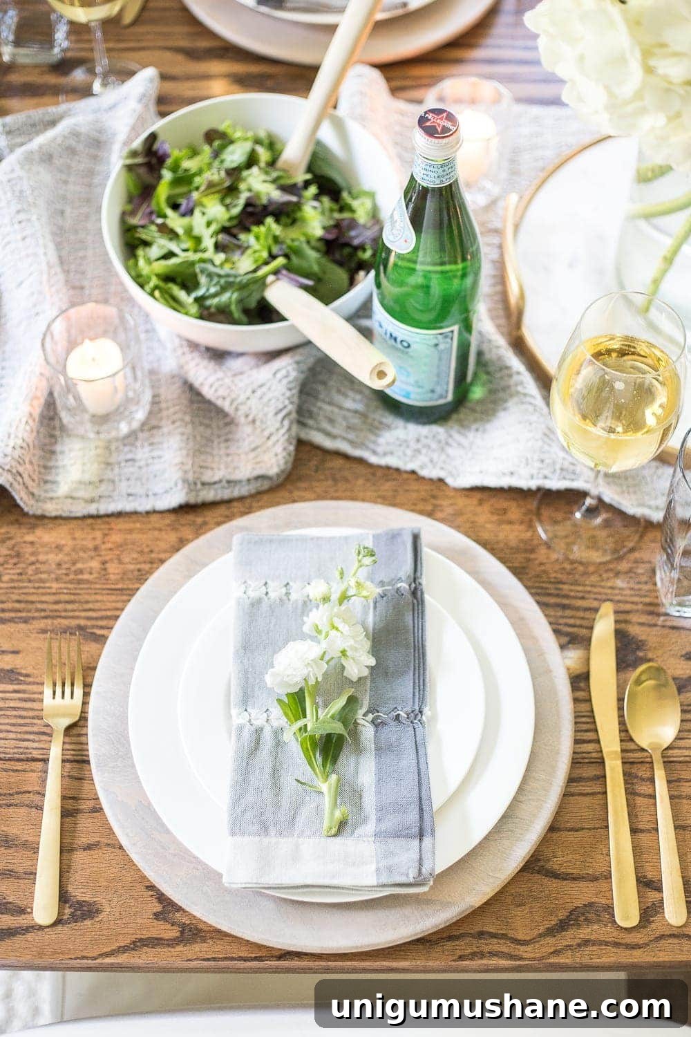 Close-up of tabletop styling with layered linens and natural elements.