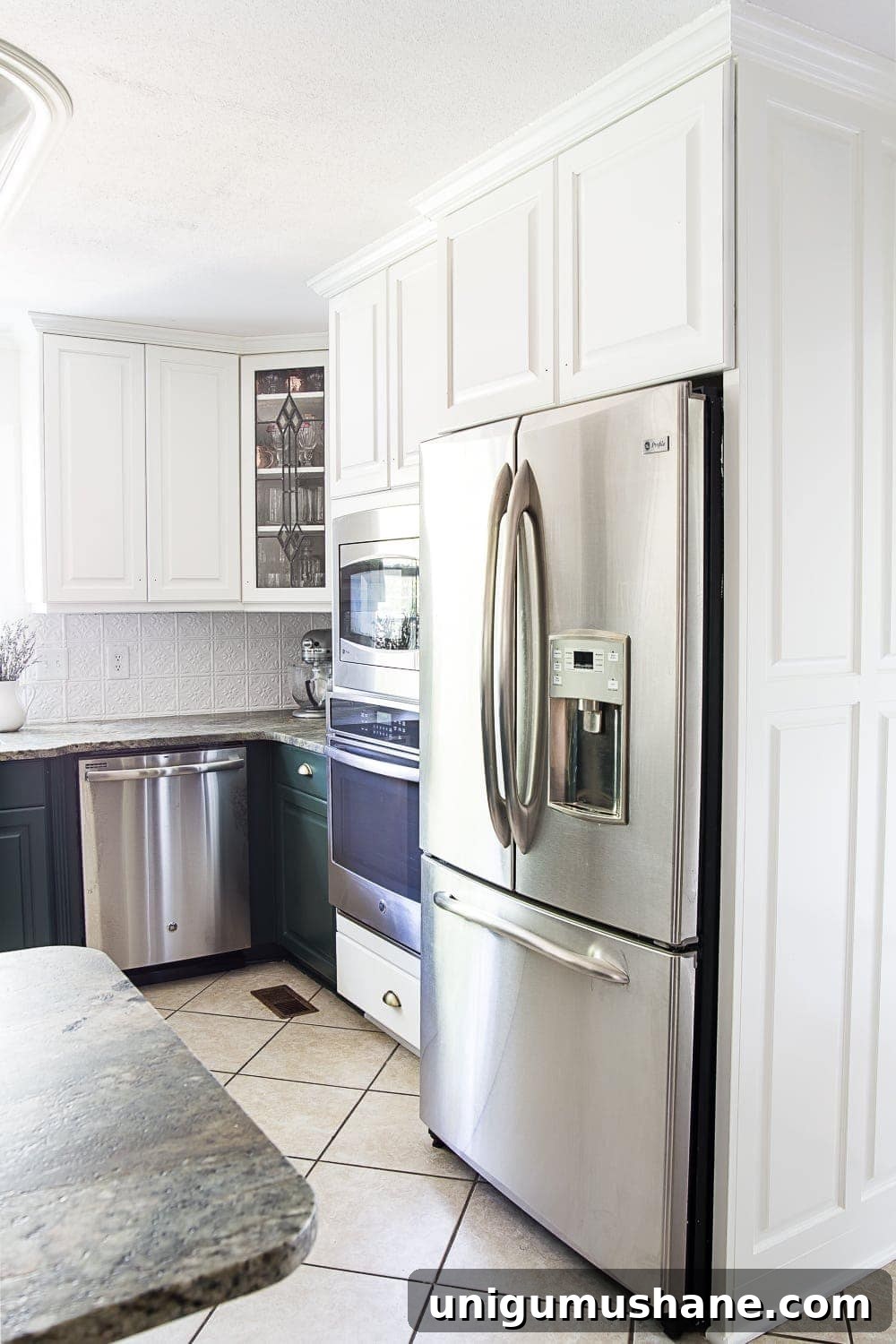 white upper and green lower kitchen cabinets stopping at wall oven & refrigerator 