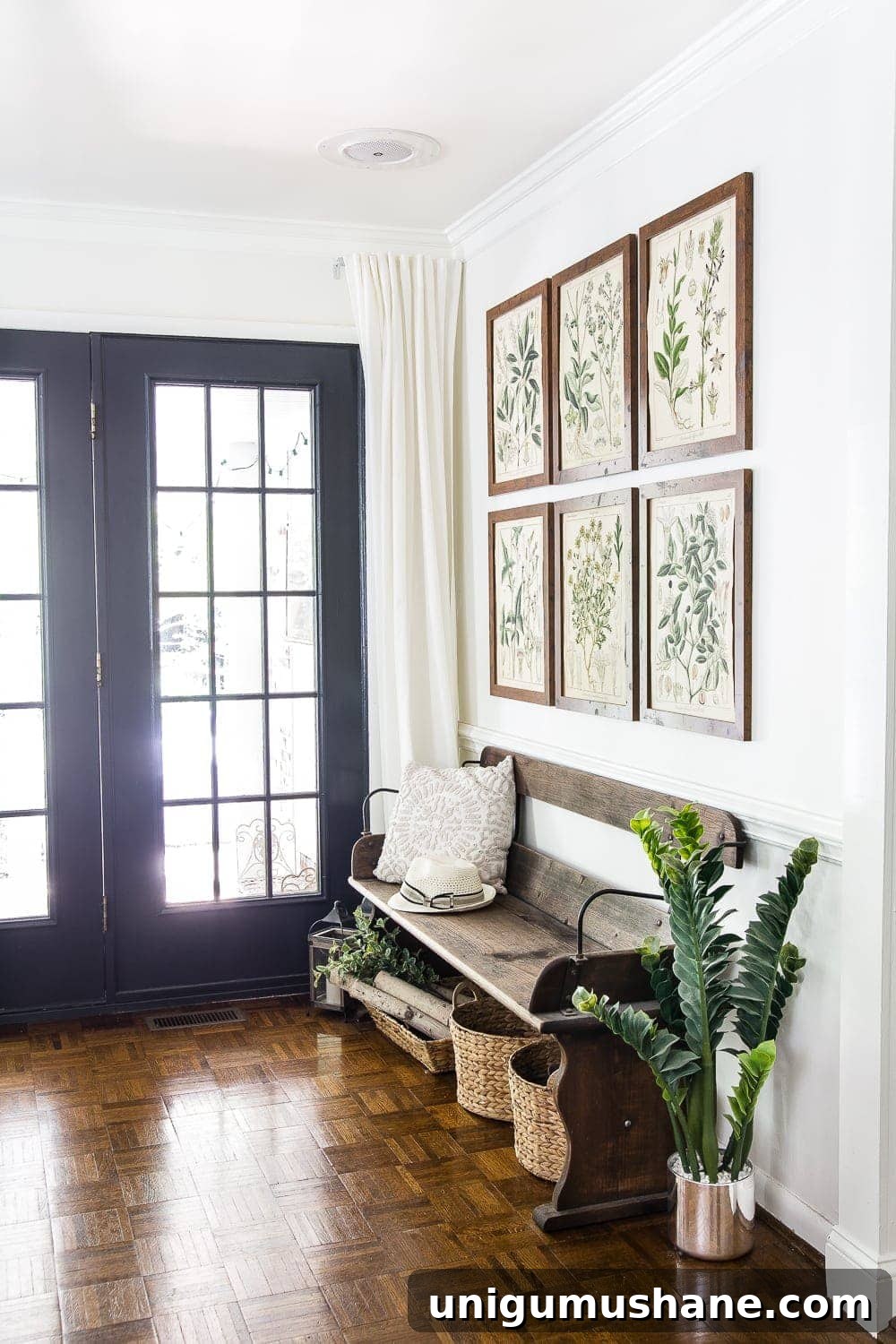 entryway with summer botanical gallery wall and reclaimed wagon bench 