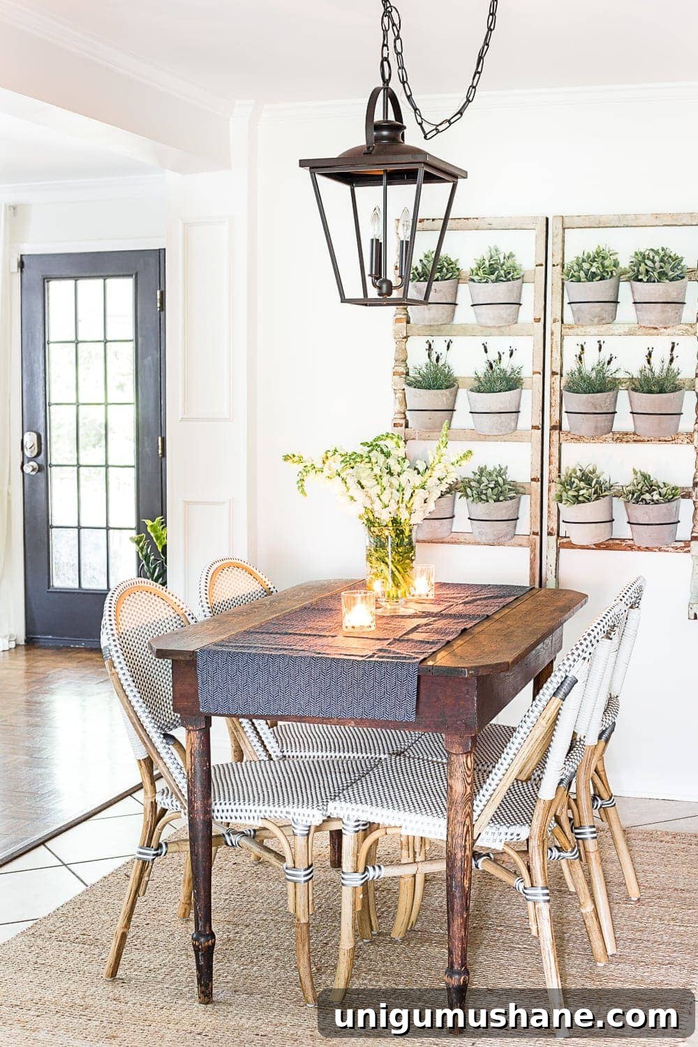 breakfast nook decorated for summer with a DIY wall planter made from antique banisters