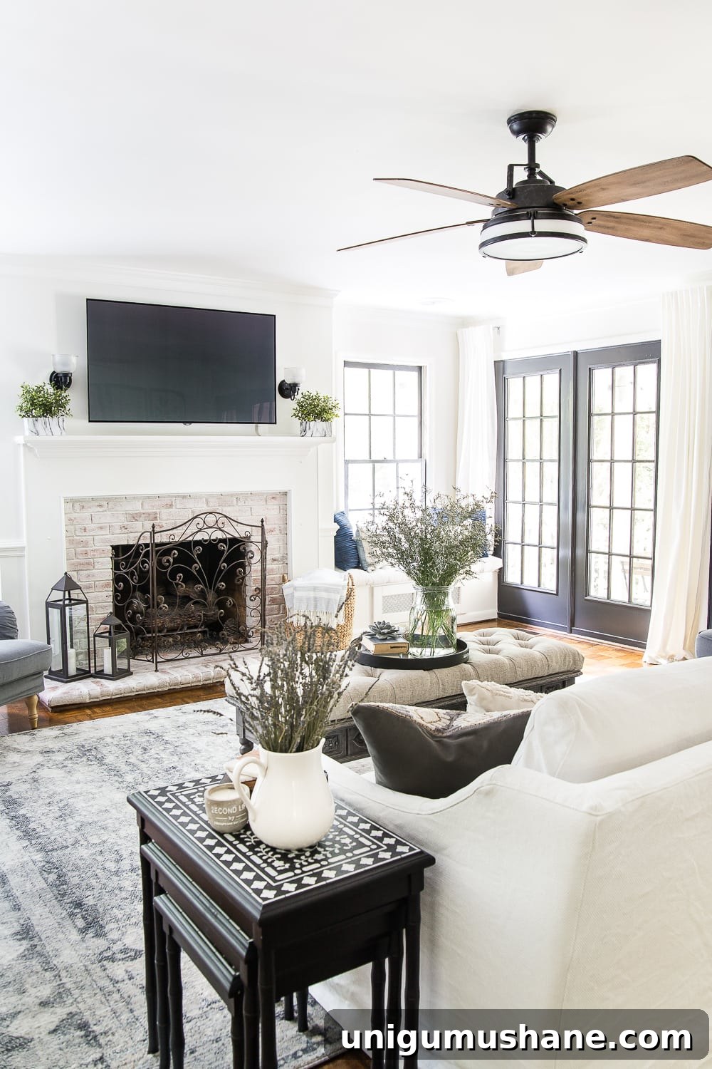 summer living room with limewashed brick fireplace