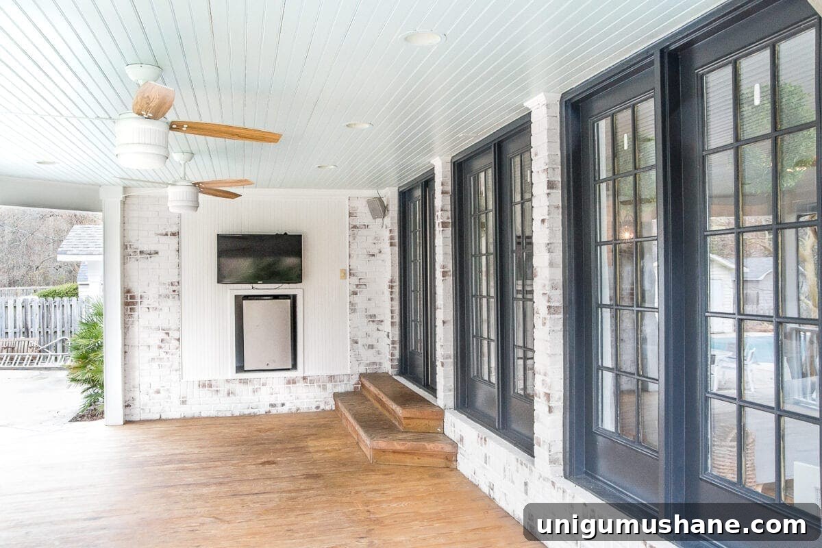 Summer Back Porch Tour: Inspiring Decor and Outdoor Styling 5 limewashed brick back porch with haint blue ceiling and black doors