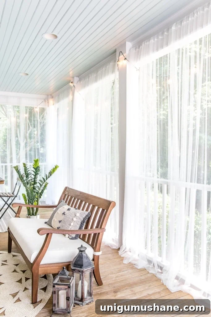 DIY Screened Porch and Outdoor Curtains for Under $100 6 mosquito net outdoor curtains on back porch with haint blue ceiling
