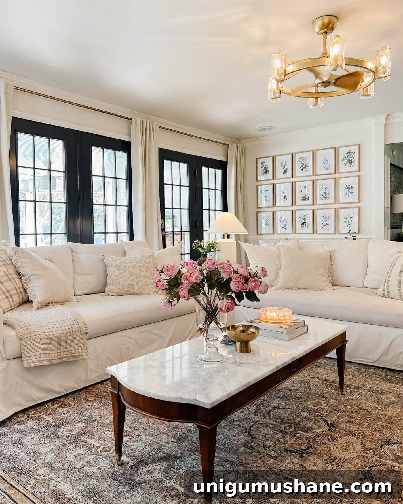 23 Small Room Tricks That Make Any Space Look Bigger 12 living room with white walls, black French doors, and white sofas with a rug and marble topped coffee table