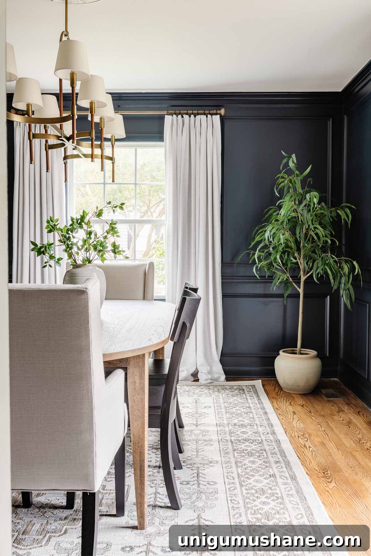 23 Small Room Tricks That Make Any Space Look Bigger 9 navy blue small dining room with white curtains, Scandinavian rug, and artificial tree