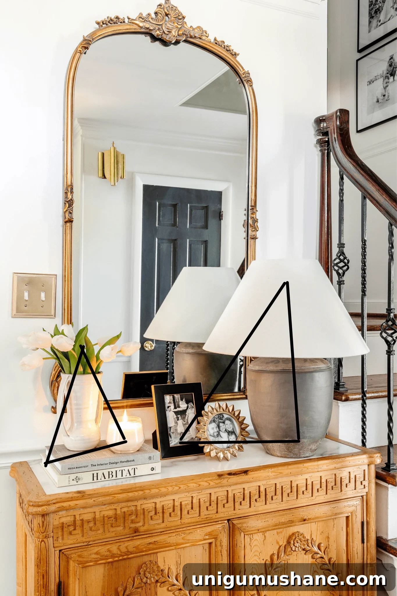 23 Small Room Tricks That Make Any Space Look Bigger 10 small entryway with gold mirror, concrete lamp, and storage chest