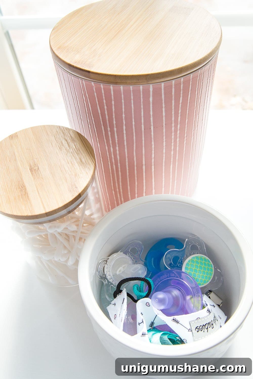 Nursery Organization Tour: Baby Room Storage and Layout 6 Nursery Organization | Use lidded canisters from the kitchenware aisle to store pacifiers.