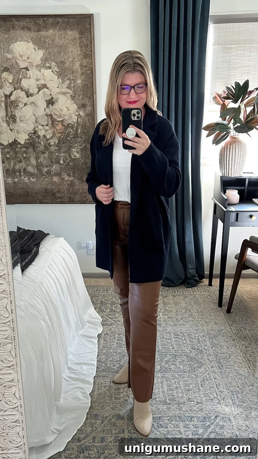 postpartum outfit with leather pants, tee, and cardigan