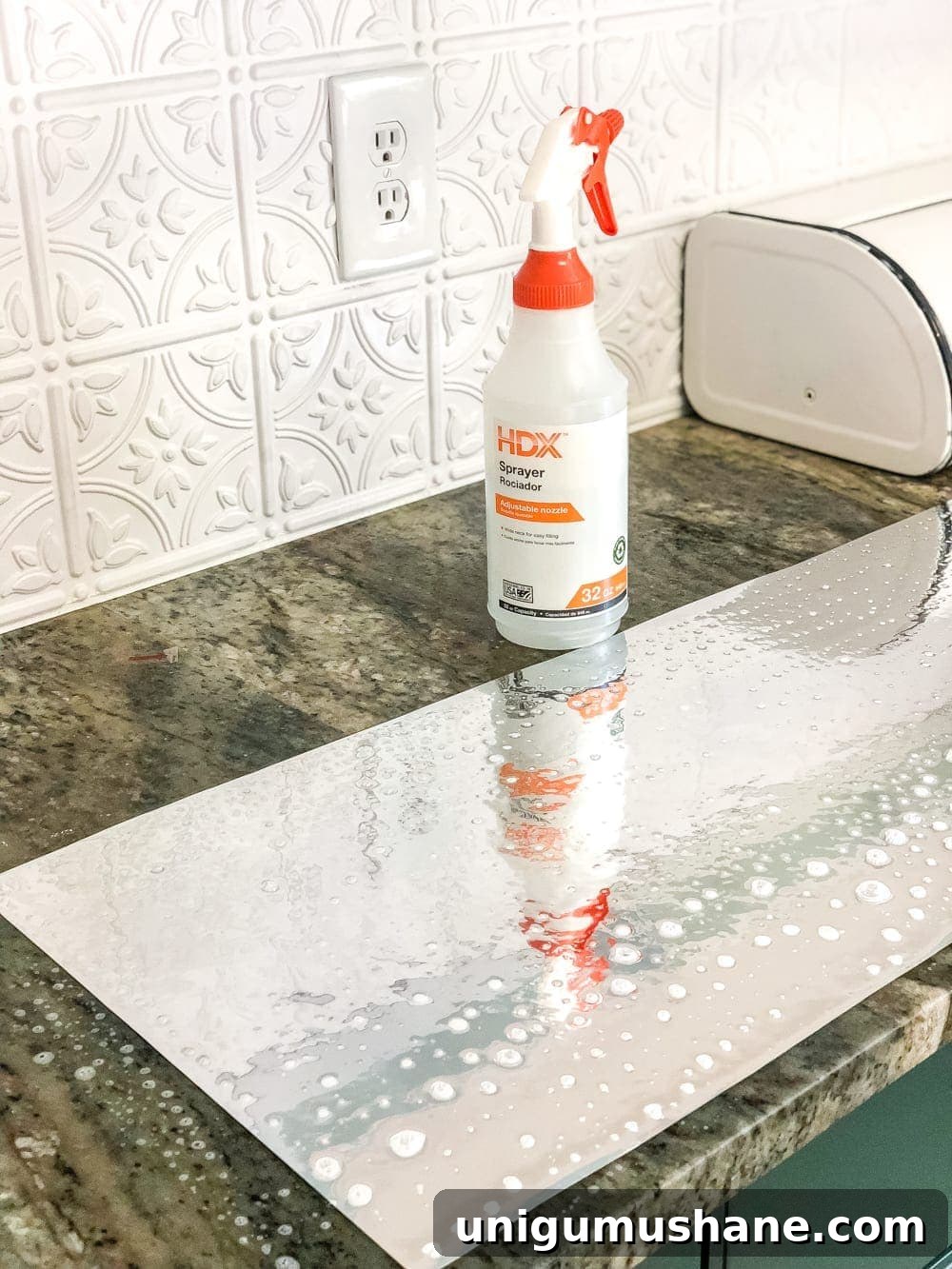 Build an IKEA Pantry Cabinet with Hemnes 12 applying antique mirror film by spritzing with water in a spray bottle