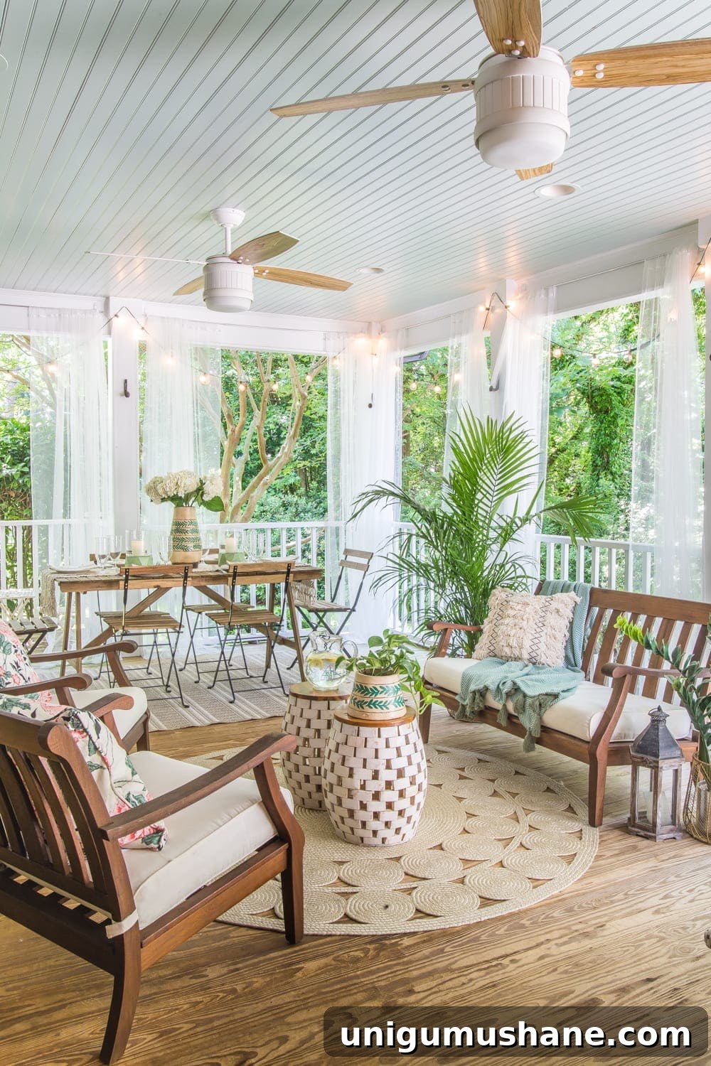 Boho Summer Back Porch Makeover Ideas 2 A tropical boho back porch decorated for summer with breezy, functional style from Flower Home and string lights for evening ambience.