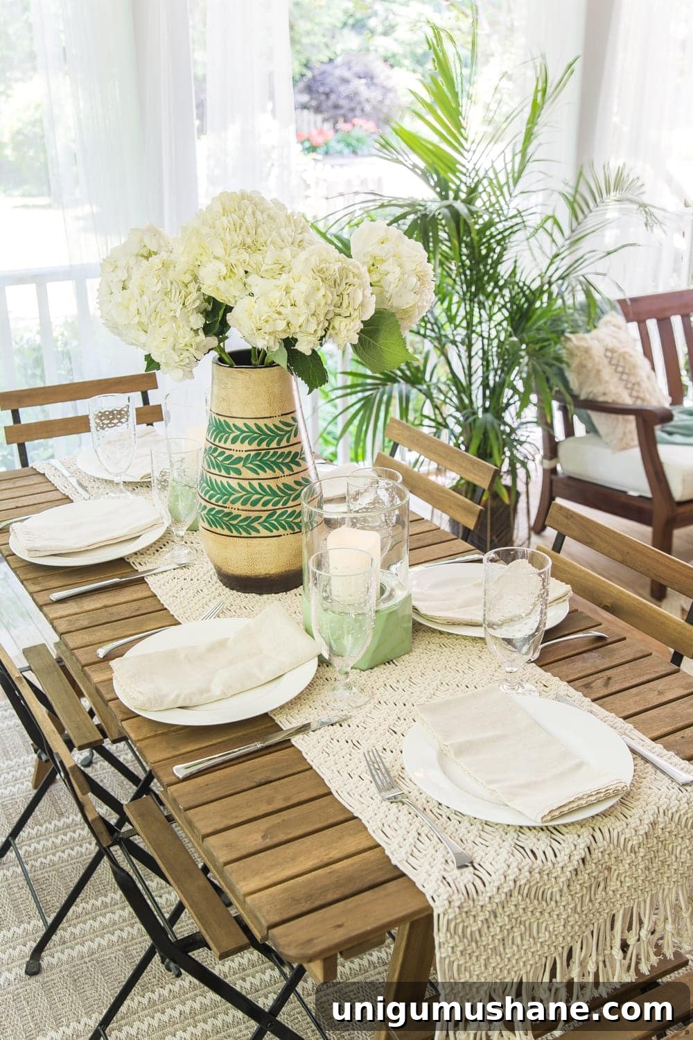Boho Summer Back Porch Makeover Ideas 12 A tropical boho back porch decorated for summer with breezy, functional style from Flower Home and string lights for evening ambience.