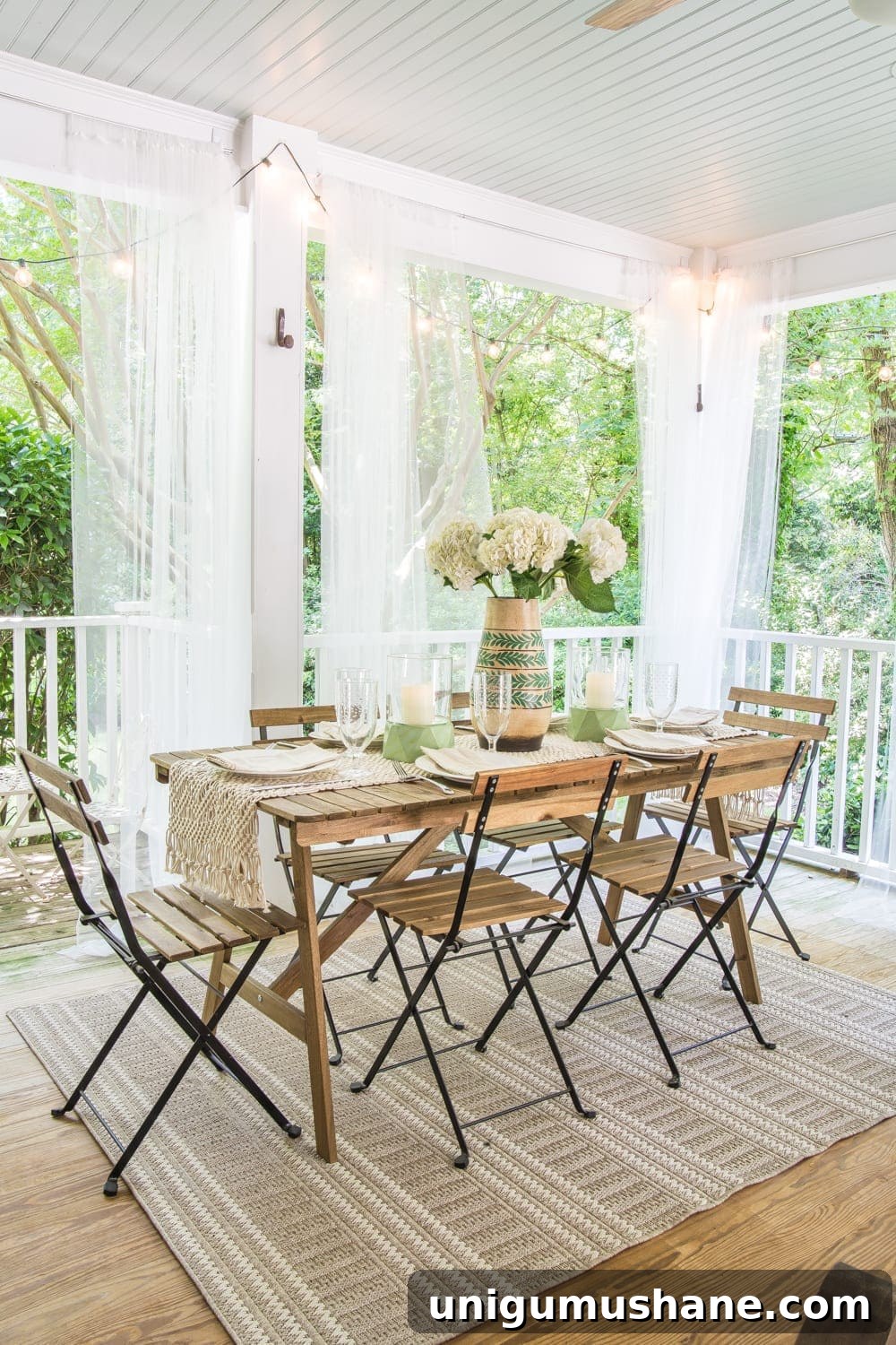 Boho Summer Back Porch Makeover Ideas 14 A tropical boho back porch decorated for summer with breezy, functional style from Flower Home and string lights for evening ambience.
