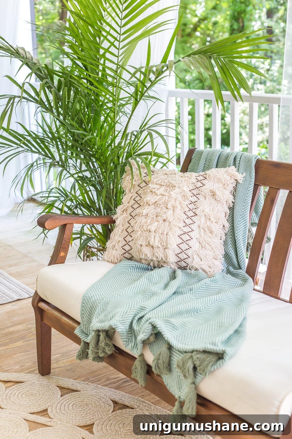 Boho Summer Back Porch Makeover Ideas 6 A tropical boho back porch decorated for summer with breezy, functional style from Flower Home and string lights for evening ambience.